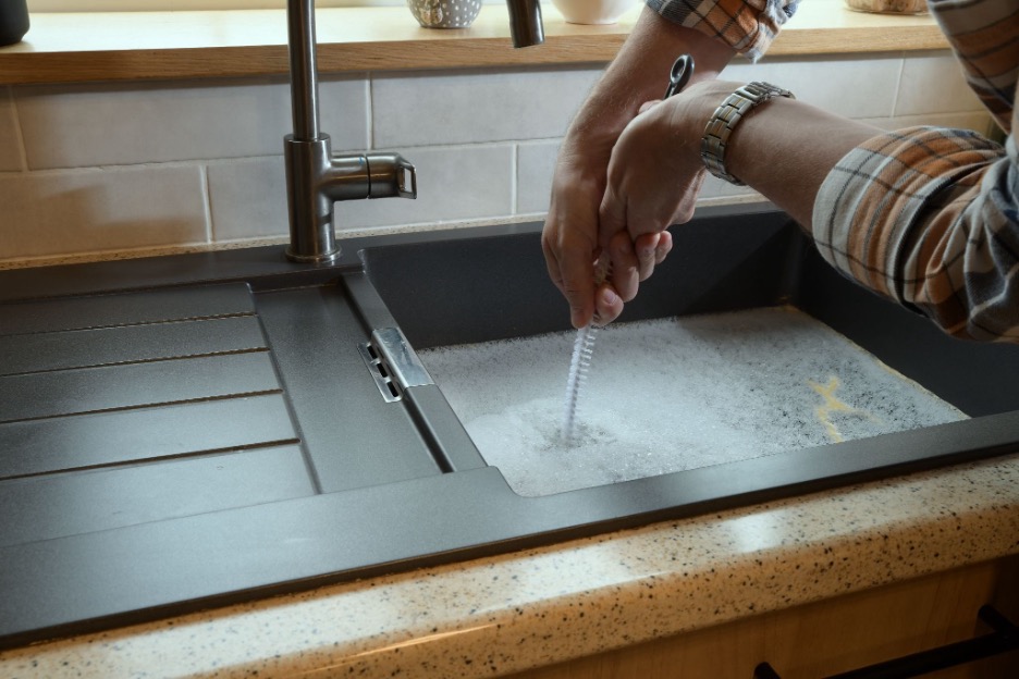 A sink that is full of water because the drain is clogged.